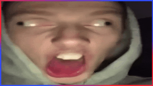 a close up of a person making a funny face with their mouth wide open .