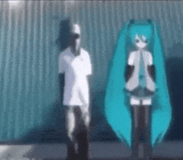 a man and a woman are standing next to each other in front of a wall .