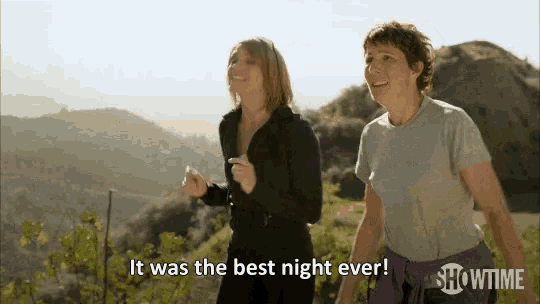 two women are walking on a trail and one of them is saying it was the best night ever