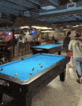 pool tables in a room with a sign that says ' a ' on it