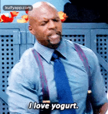 a man in a suit and tie is sticking out his tongue and saying `` i love yogurt '' .