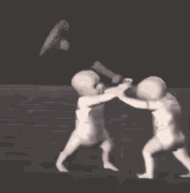 a group of babies are fighting with a hammer .