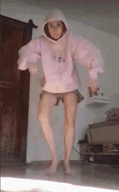a woman in a pink hoodie with the number 9 on it