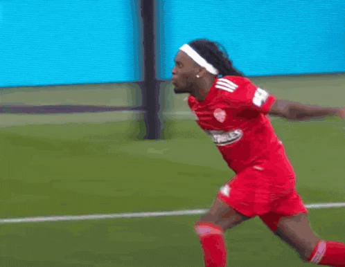 a soccer player wearing a red jersey that says bet on it