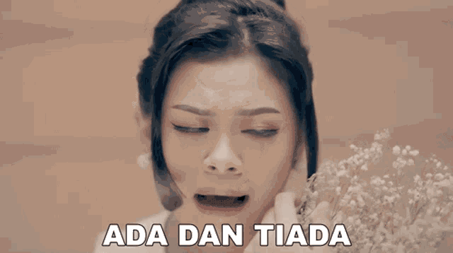 a woman with a flower in her hand and the words ada dan tiada written below her