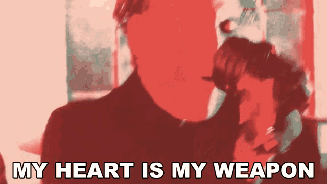 a blurred image of a man with the words " my heart is my weapon " below him