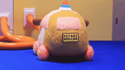 a stuffed animal with a sign that says retake molcar