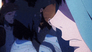 a close up of a person 's face with a blue hood on .