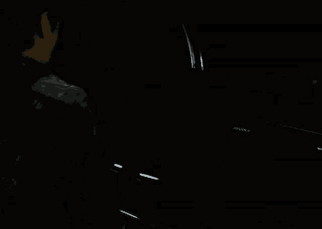 a man in a dark room is holding a mark ii
