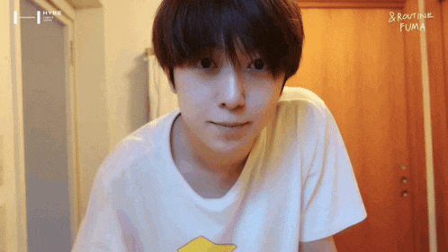 a person wearing a white t-shirt with routine fuma written on the bottom