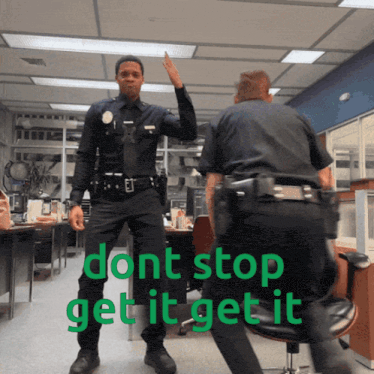 two police officers giving each other a high five in an office with the words " dont stop get it get it "