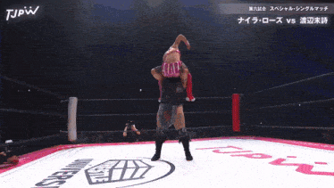 two women wrestling in a ring with jpw written on the bottom of the screen