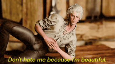 a man laying on the floor with the words " do n't hate me because i 'm beautiful " on the bottom