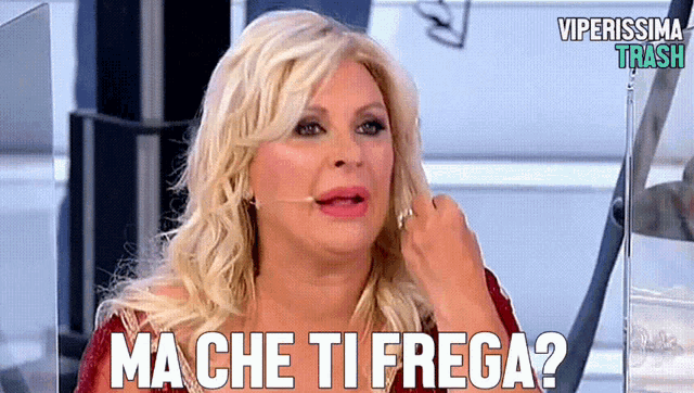 a woman with blonde hair and the words ma che ti frega on her face