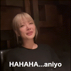 a woman is laughing with the words ' hahaha..aniyo ' written below her