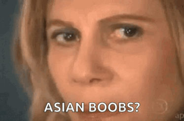 a close up of a woman 's face with the words asian boobs .