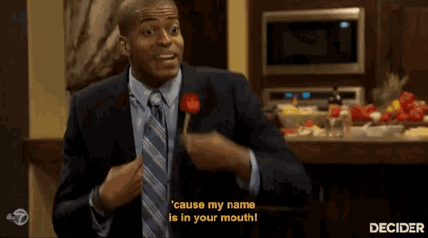 a man in a suit and tie says cause my name is in your mouth