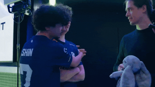 a man in a shin number 3 jersey talks to another man