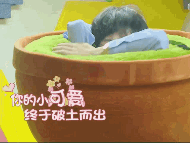 a person in a pot with chinese writing on the bottom
