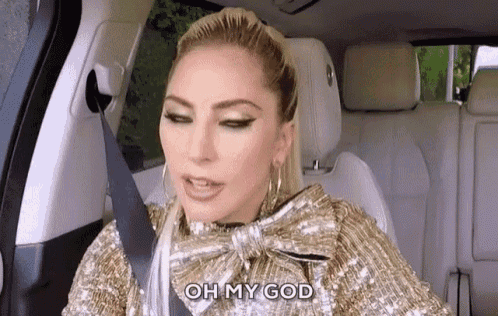 lady gaga is sitting in the back seat of a car wearing a seat belt and a bow tie .