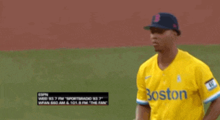 a baseball player wearing a yellow jersey that says boston