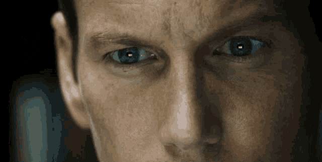a close up of a man 's blue eyes looking at the camera