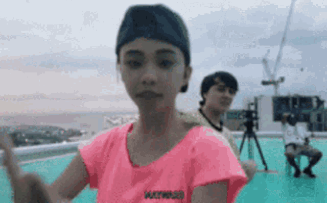 a woman wearing a pink shirt that says ' walking ' on it