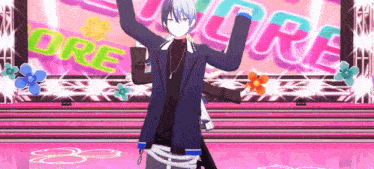 a man is standing on a stage with his arms in the air in front of a sign that says ore .