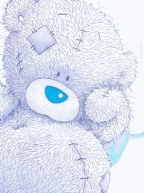 a purple teddy bear with a blue eye and stitches on its face