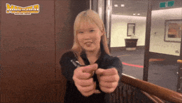 a woman is pointing at the camera with a sign that says madman