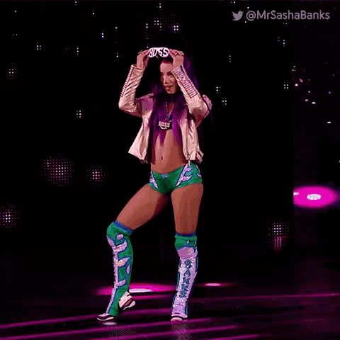 a woman with purple hair is dancing on a stage