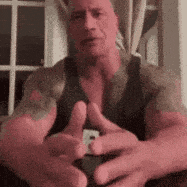a man with a lot of tattoos on his arms is giving a thumbs up sign .