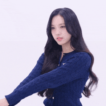 a woman wearing a blue sweater with a gold letter y on the front