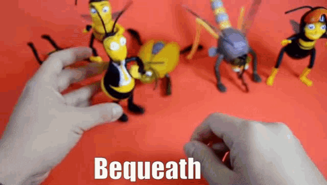 a person is playing with a bunch of bee toys on a red table .