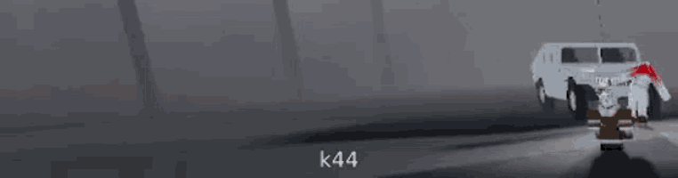 a white jeep is driving down a road next to a red and white object in a dark room .