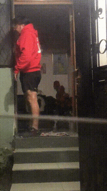 a man in a red hoodie with the number 1 on the back