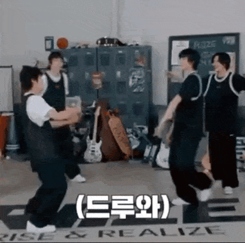 a group of people are dancing in a room with a sign that says rise and realize .