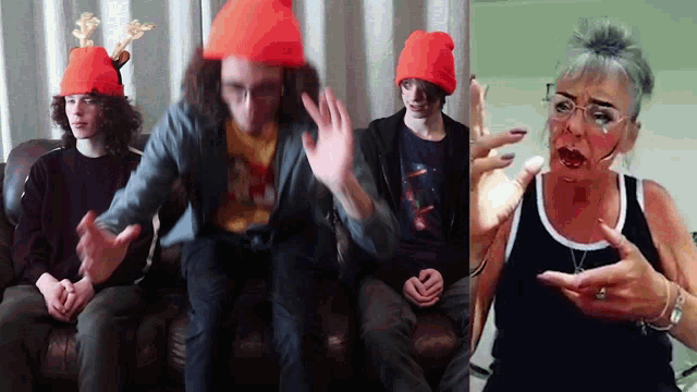 a group of people sitting on a couch wearing orange beanies