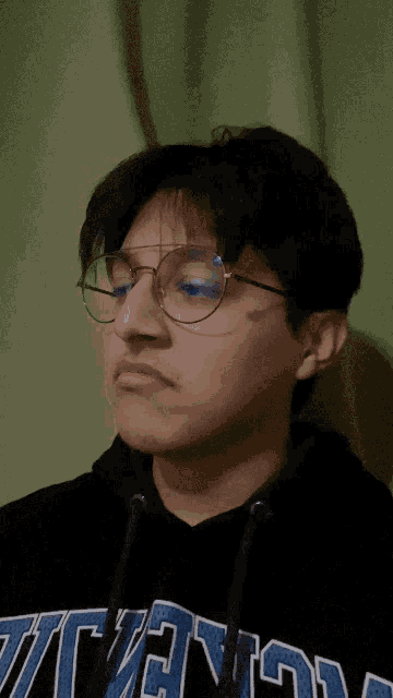 a young man wearing glasses and a hoodie that says ucsd