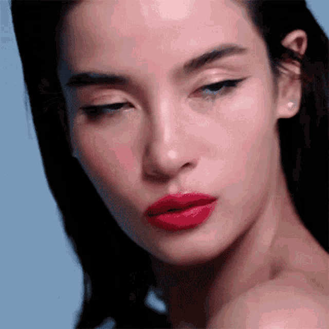 a close up of a woman with red lipstick on her lips