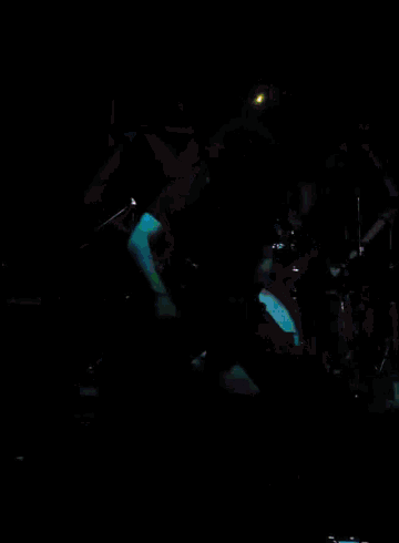 a man playing a guitar on stage with a marshall amplifier in the background