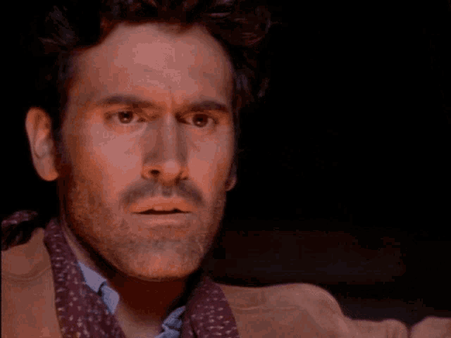 a man with a beard and a scarf around his neck