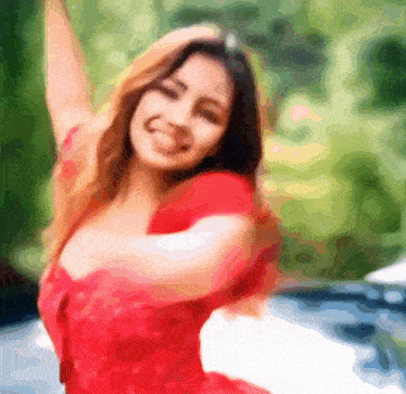 a woman in a red dress has her arms outstretched