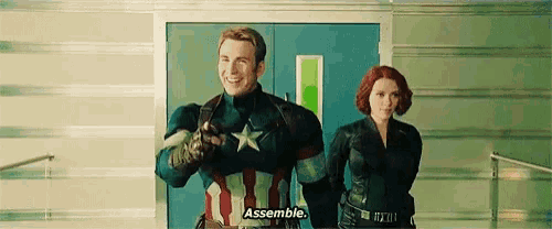captain america and black widow are standing next to each other in a room .