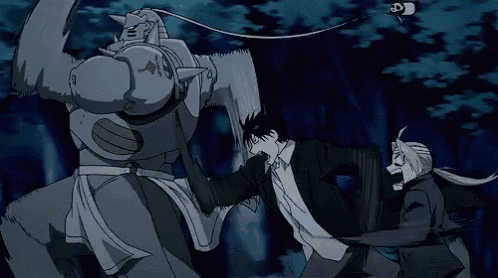 a man and a robot are fighting in a forest .