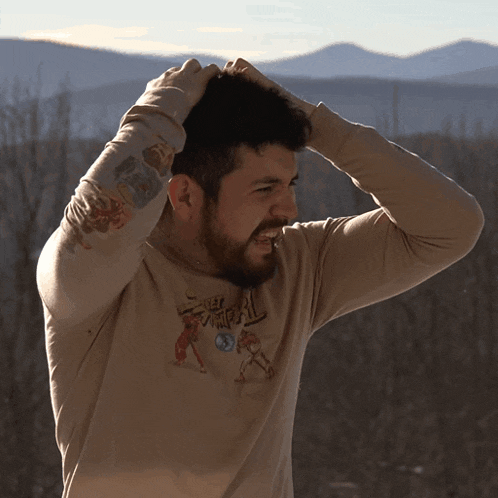 a man wearing a shirt that says samurai holds his head