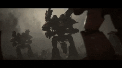 a group of giant robots are standing next to each other in the dark .