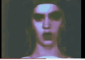 a close up of a person 's face with a purple background