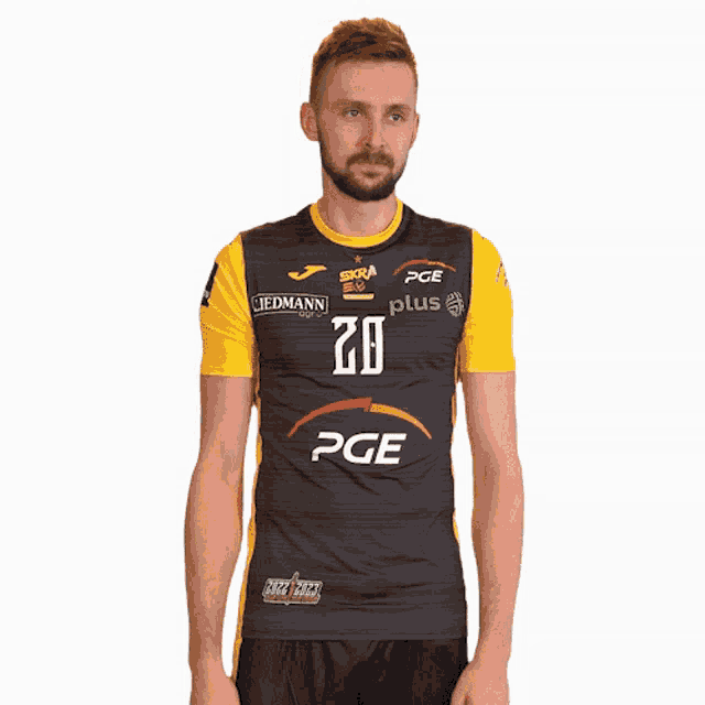 a man is wearing a black and yellow jersey with the number 20 on it