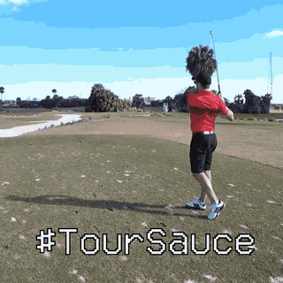 a man swinging a golf club on a golf course with #toursauce written on the ground